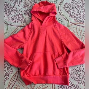 Athleta Moonrise coral hooded sweatshirt in the color coral.
Size S